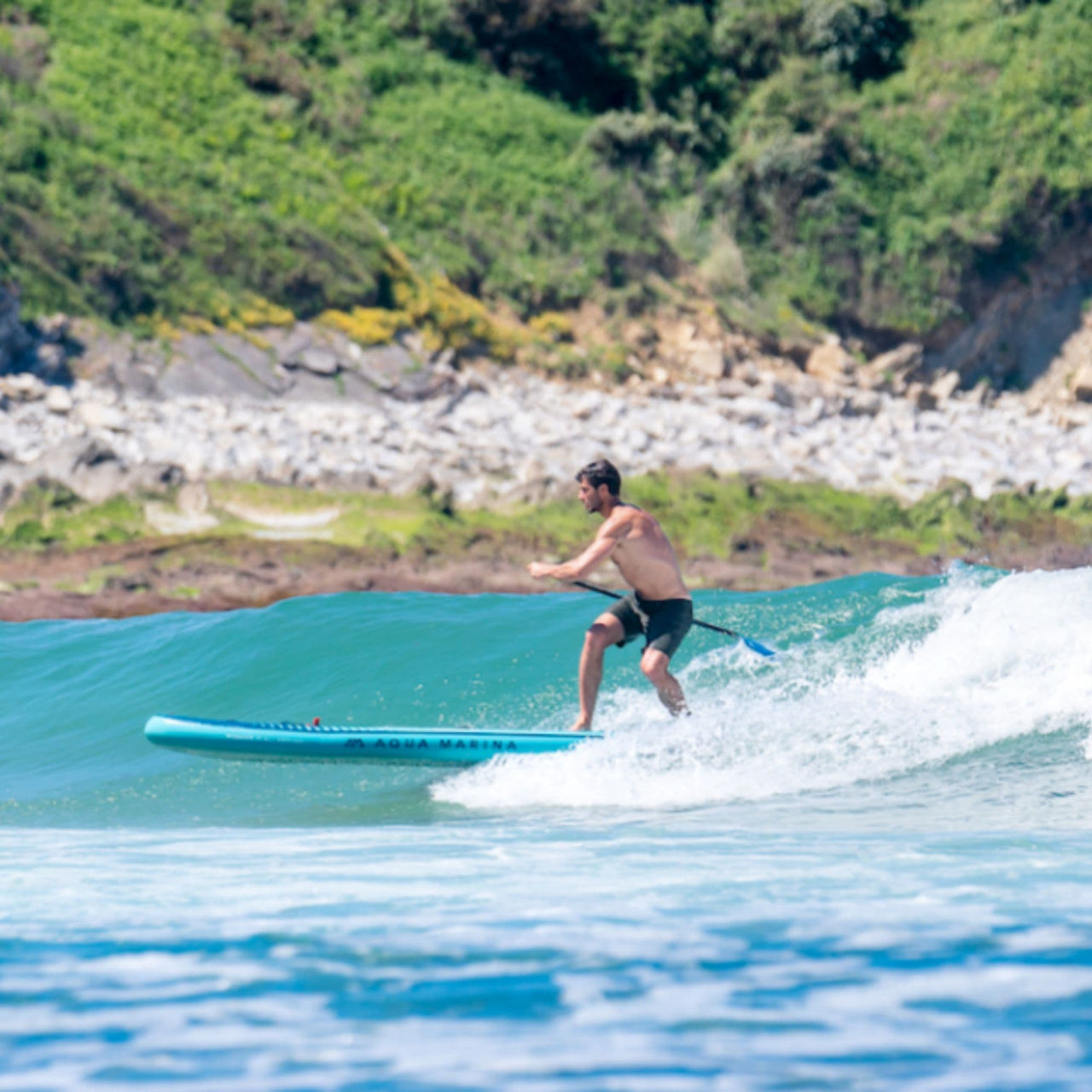Aqua Marina Beast Paddle Board With A Man Paddling on a Waves