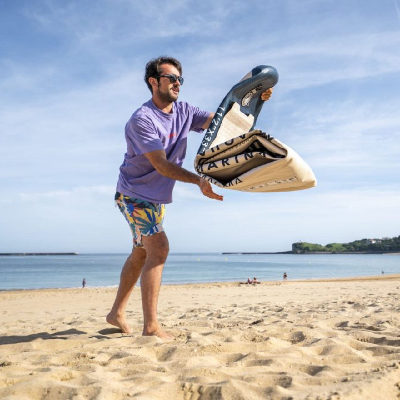 Aqua Marina Magma Sup With A Man Unfolding the Paddle Board