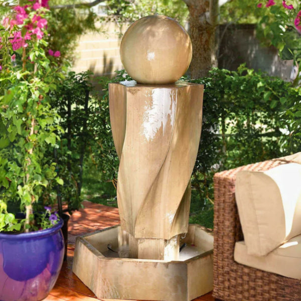Gist Vortex With Ball Outdoor Water Fountain Surrounded By Plants Besides Rattan Sofa