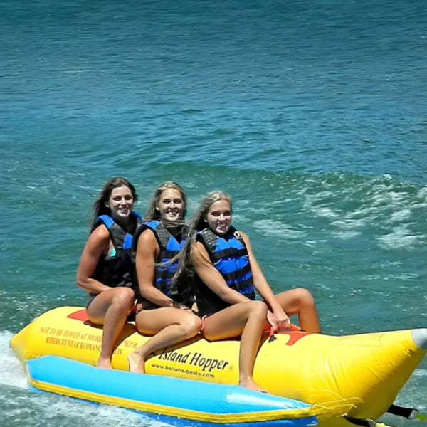 Island Hopper 3 Person Banana Boat With Three Girls Smiling While Riding Waves
