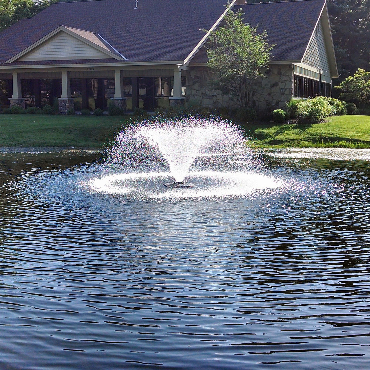 Scott Aerator DA-20 Aerating Pond Fountain On The Water With One House In The Background