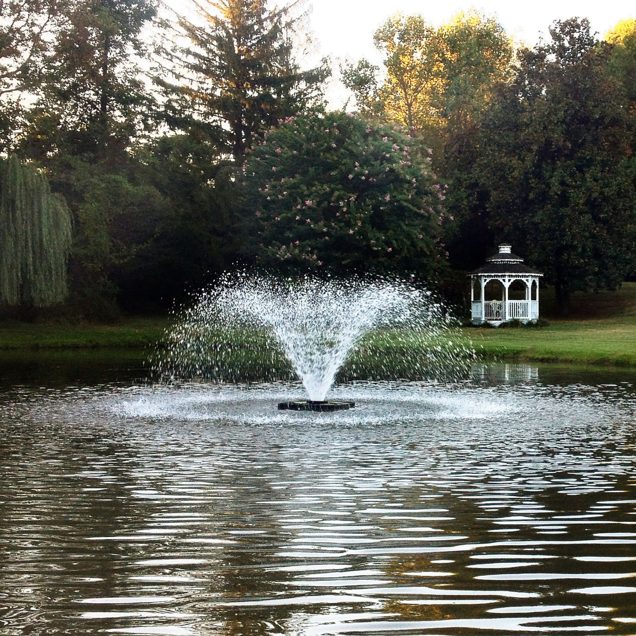 Scott Aerator DA-20 Display Pond Aerator Fountain On The Water With Trees & A Gazebo In The Background