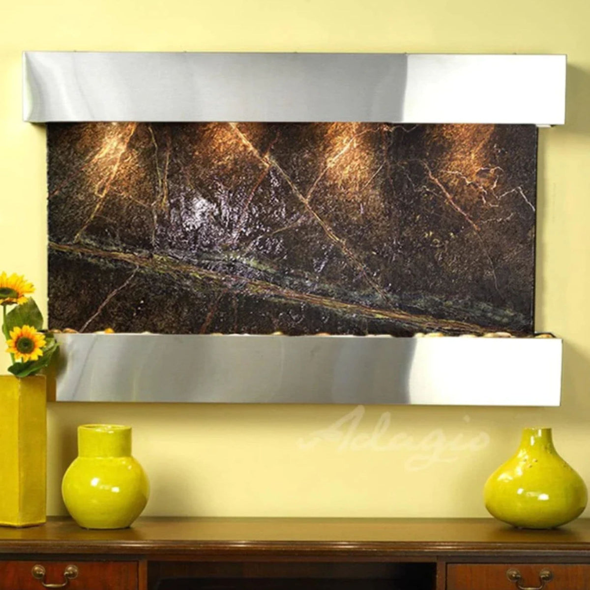 Adagio Sunrise Springs wall fountain on a yellow accent wall with sunflowers