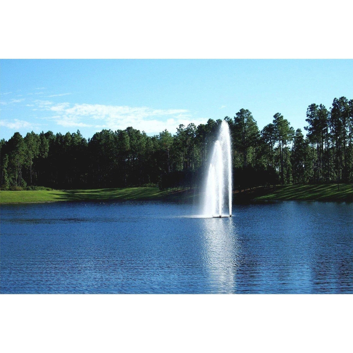 Vertex TriPod floating fountain throwing three tall water columns on a lake with open landscape behind