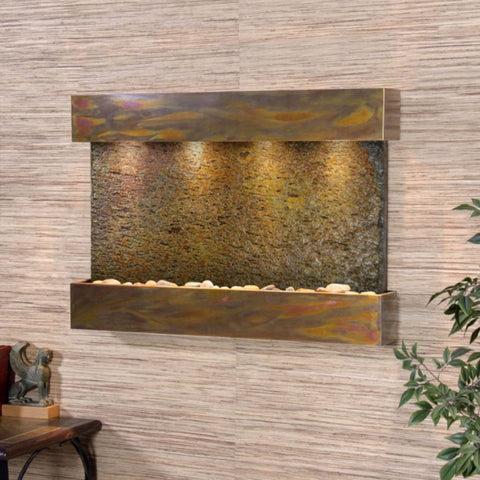 Adagio Reflection Creek Wall Fountain With Soft Lighting and Green Leaves