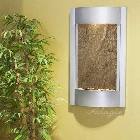 Adagio Serene Waters Wall Fountain With Yellow Wall Accent and Green Plants