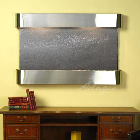 Adagio Sunrise Springs Wall Fountain for Business or Spa Spaces With A Books Piled On a Classic Furniture