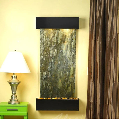Adagio Water Features Cascade Springs Wall Fountain With Metallic Table Lamp Placed On A Small Green Table
