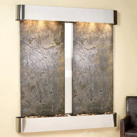 Adagio Water Features Cottonwood Falls Wall Fountain With Chocolate Brown Leather Chair Beside