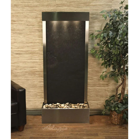 Adagio Water Features Harmony River Floor Water Fountain - Rear Mounted With Dark Brown Leather Chair and Plants in Woven Basket Planter