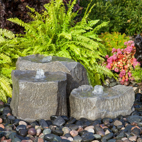 Agate Rock Garden Fountain With Fern Plants In The Back
