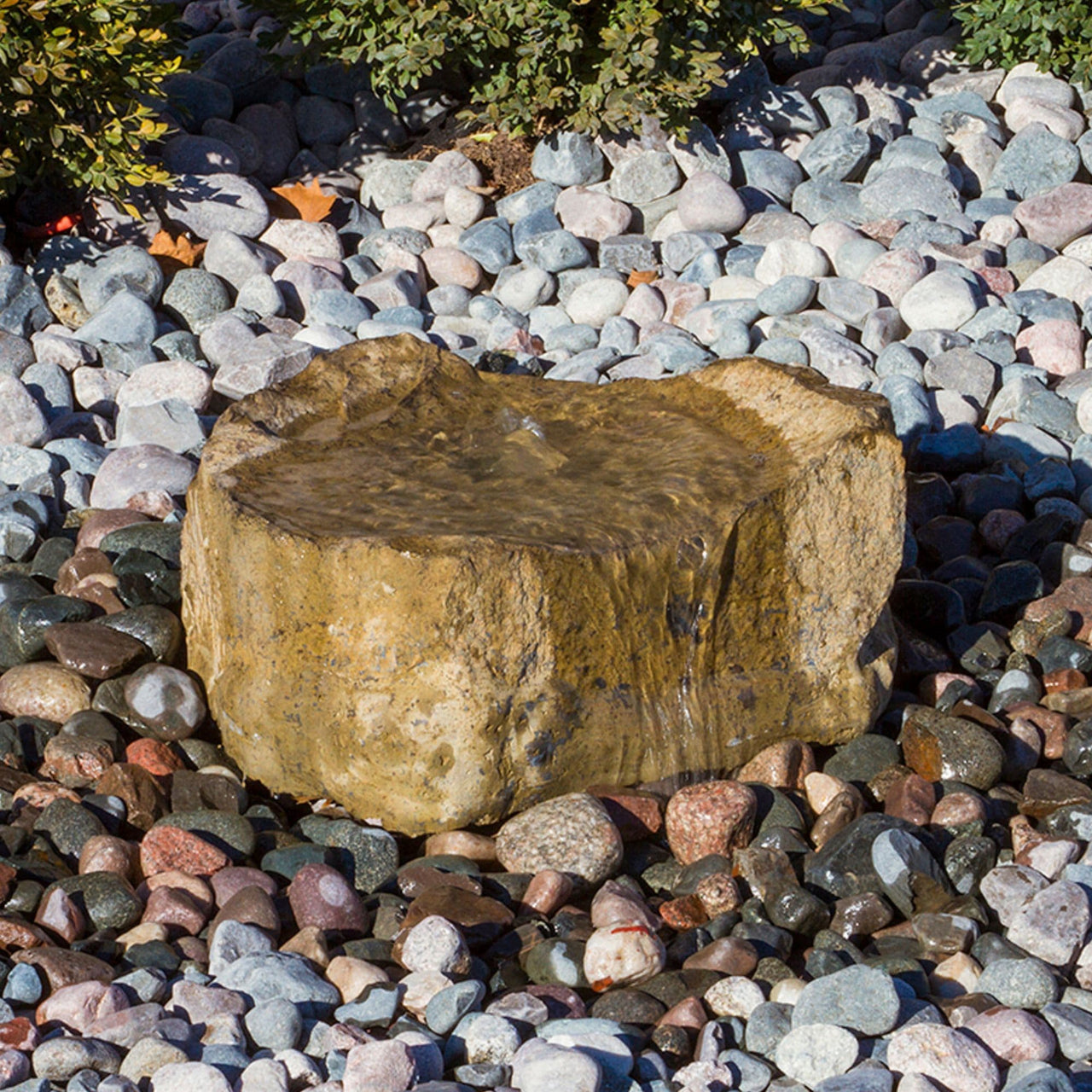 Agawa Falls Stone Outdoor Fountain Surrounded By Stones With Plants In The Back