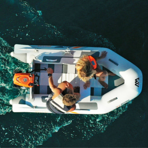Aqua Marina A-Deluxe Inflatable Speed Boat With a Boy and a Girl Steering on the Deep Sea