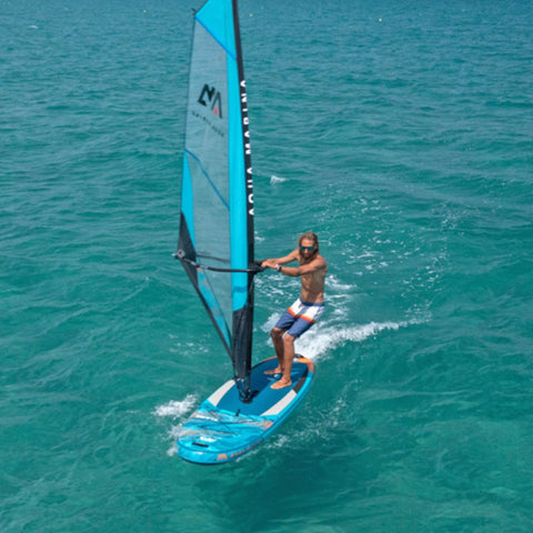 Aqua Marina Blade Windsurf Paddle Board With A Man Riding On The Water