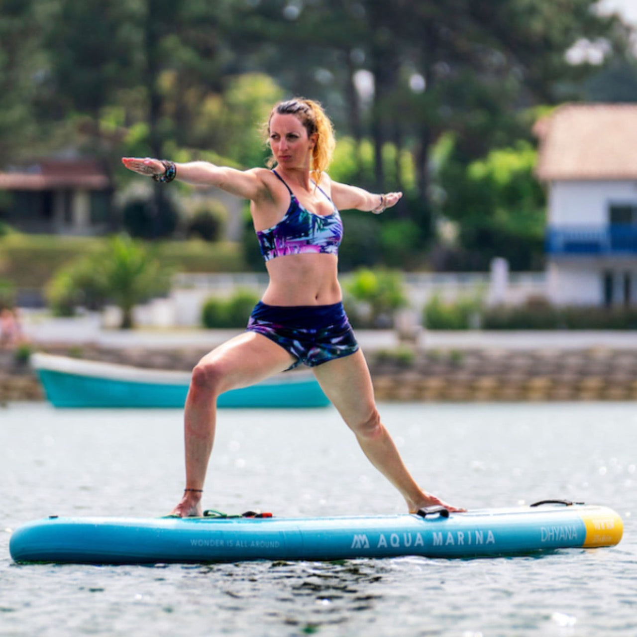 Aqua Marina Dhyana SUP With A Woman Balancing While Doing Yoga On Board