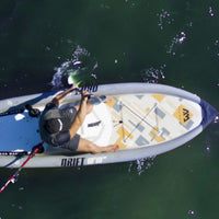 Thumbnail for Aqua Marina Drift Fishing Paddle Board With A Seated Man While Paddling On The Water