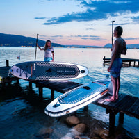 Thumbnail for Aqua Marina Glow Paddle Board With A Man And Woman Standing And Getting Ready