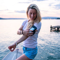 Thumbnail for Aqua Marina Glow Paddle Board With A Woman Holding her Arm Strap