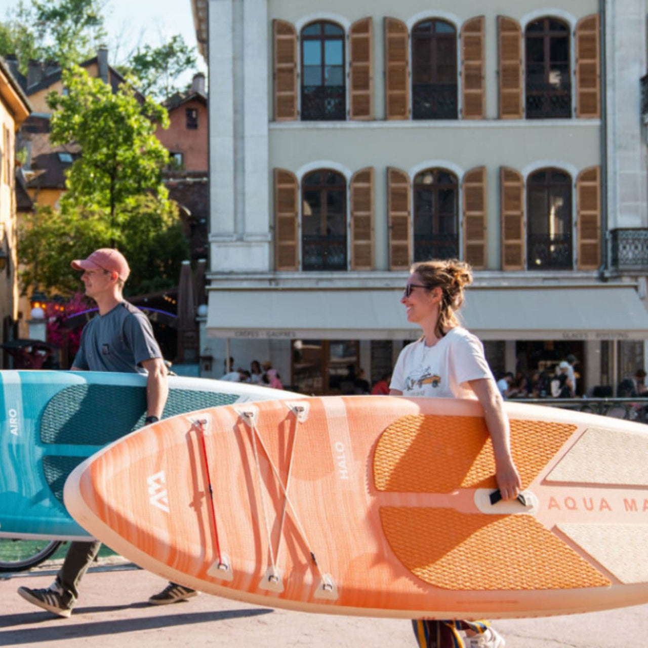 Aqua Marina Halo Inflatable Paddle Board A Man And A Woman Walking While Carrying The Boards