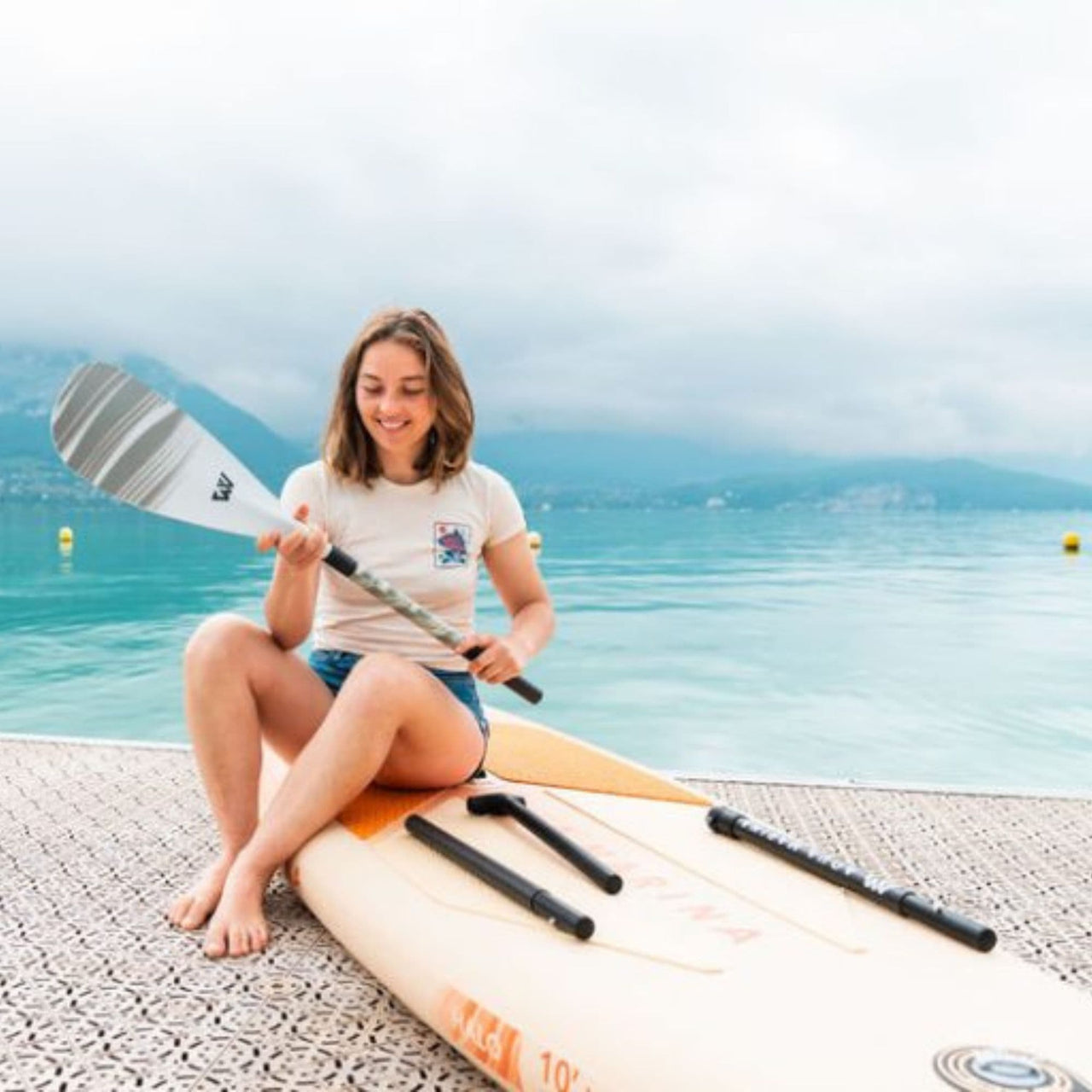 Aqua Marina Halo SUP Girl Sitting On Board At The Sea