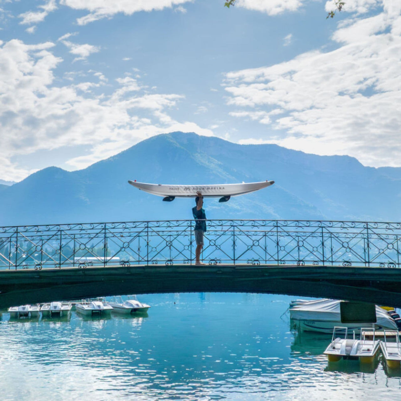 Aqua Marina Halve With A Man Carrying The Kayak On The Bridge