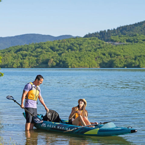 Aqua Marina Steam Kayak With A Couple Prepares To tart Their Kayaking