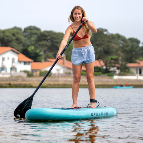 Aqua Marina Vapor SUP with a Girl Paddling in The Water
