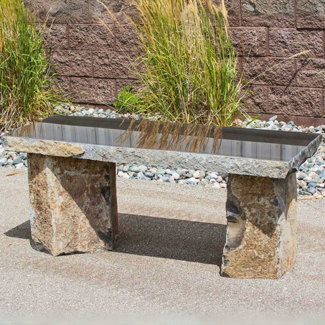 Basalt 48 Garden Bench With Red Brick Wall And Garden Grass In The Background 