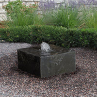 Thumbnail for Basalt Garden Fountain With Green Plants And Brick Wall In The Background