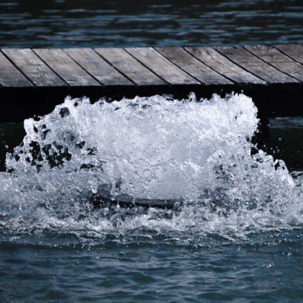 Bearon Aquatics Power House Surface Aerator On The Water Bubbling In Front Of A Pier