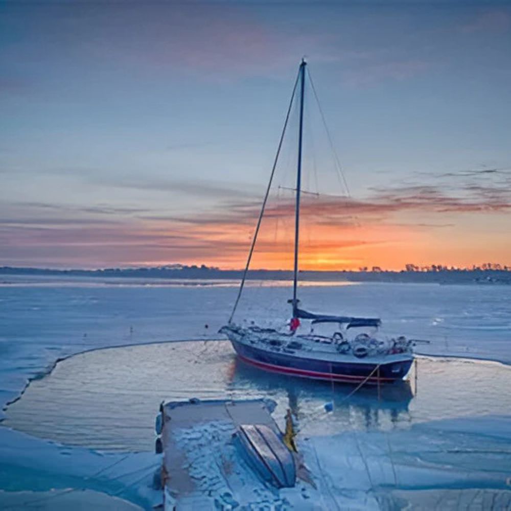 Bearon Aquatics Ice-Eater De-Icer In Icy Water Near A Boat At Sunset