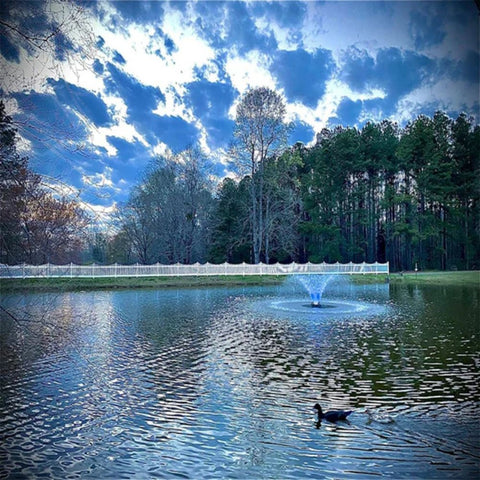 Bearon Aquatics Power House Aerating Fountain On The Water With A Blue Light & A Fence In The Background