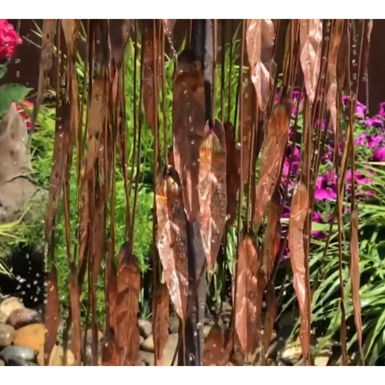 Blue Thumb 37 Copper Weeping Willow Garden Fountain With Red And Pink Flowers Plus Green Plants In The Back