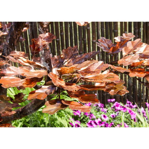 Blue Thumb 70 Copper Extra Tall Maple Tree Garden Fountain With Bamboo Fence In The Back And Flowers In Front
