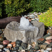 Blue Thumb Agawa Falls Stone Outdoor Fountain With  Small Trees In The Back And Surrounded By Stones