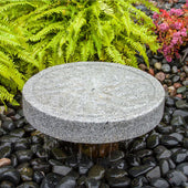 Blue Thumb Angled Millstone Granite Stone Fountain With  Fern Plants In The Background