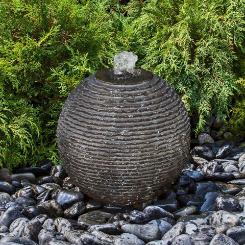 Blue Thumb Black Ribbed Granite Sphere Fountain With Bushes In The Background