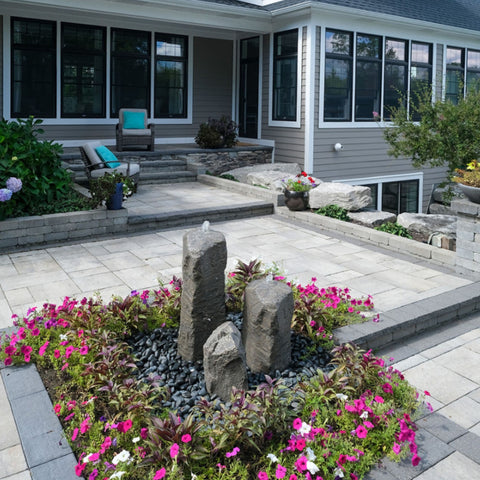 Blue Thumb Double Cascade Stone Fountain with Accent Rock In Front Of A Beautiful House