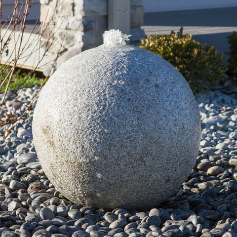 Blue Thumb Granite Sphere Stone Fountain With Plants In The Background