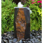 Blue Thumb Kazan Stone Outdoor Fountain With Green Plants Behind