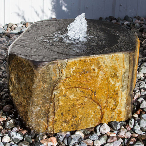 Blue Thumb Keki Stone Outdoor Fountain Surrounded By Pebbles And Metal Fence