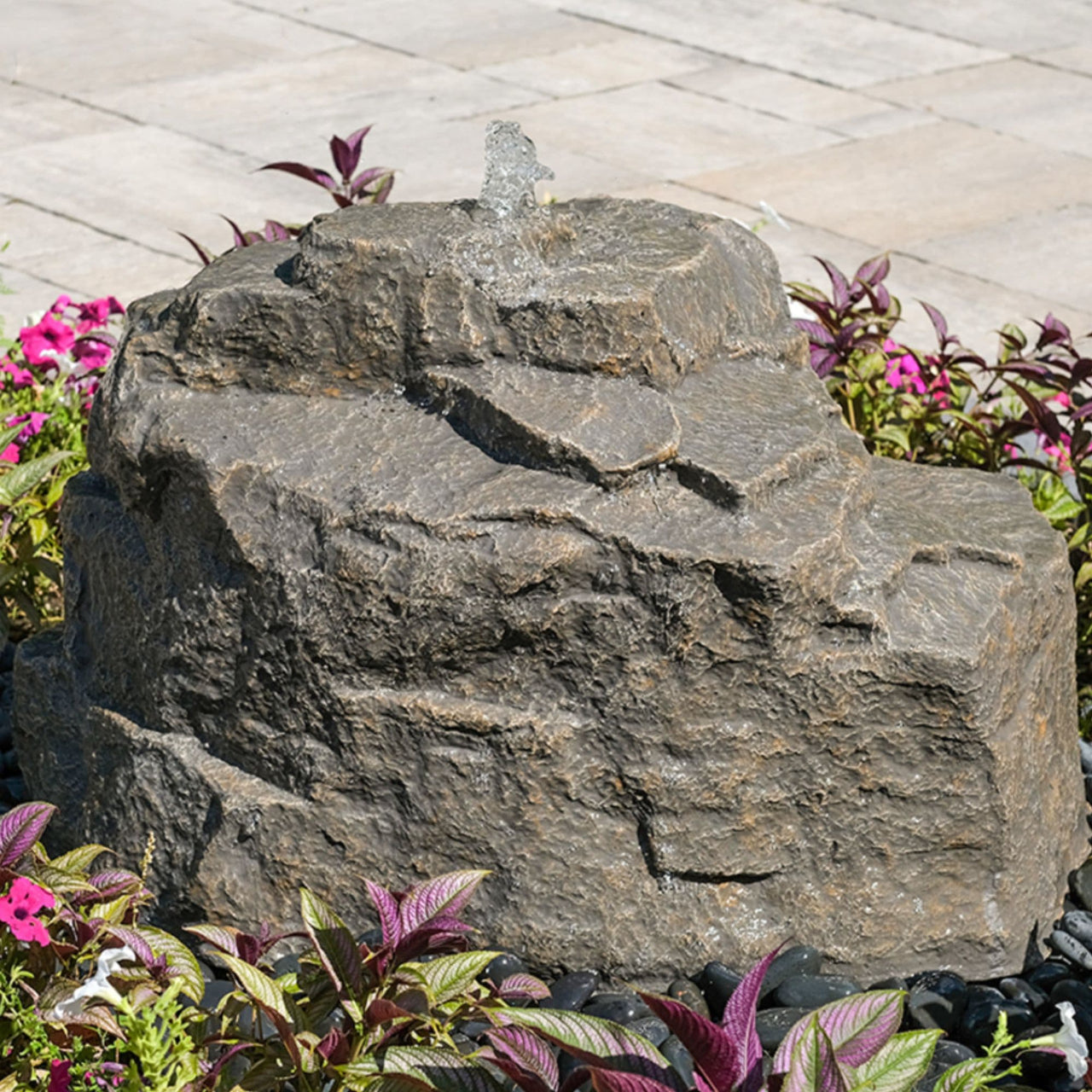Blue Thumb Mountain Spring Rock Outdoor Fountain Surrounded By Ornamental Plants
