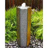 Blue Thumb Octagon Basalt Stone Tower Fountain With Green Plants And Bamboo Fence Backdrop