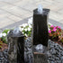 Thumbnail for Blue Thumb One Side Polished Basalt Stone Fountain Slightly Top View With White And Pink Flowers Behind