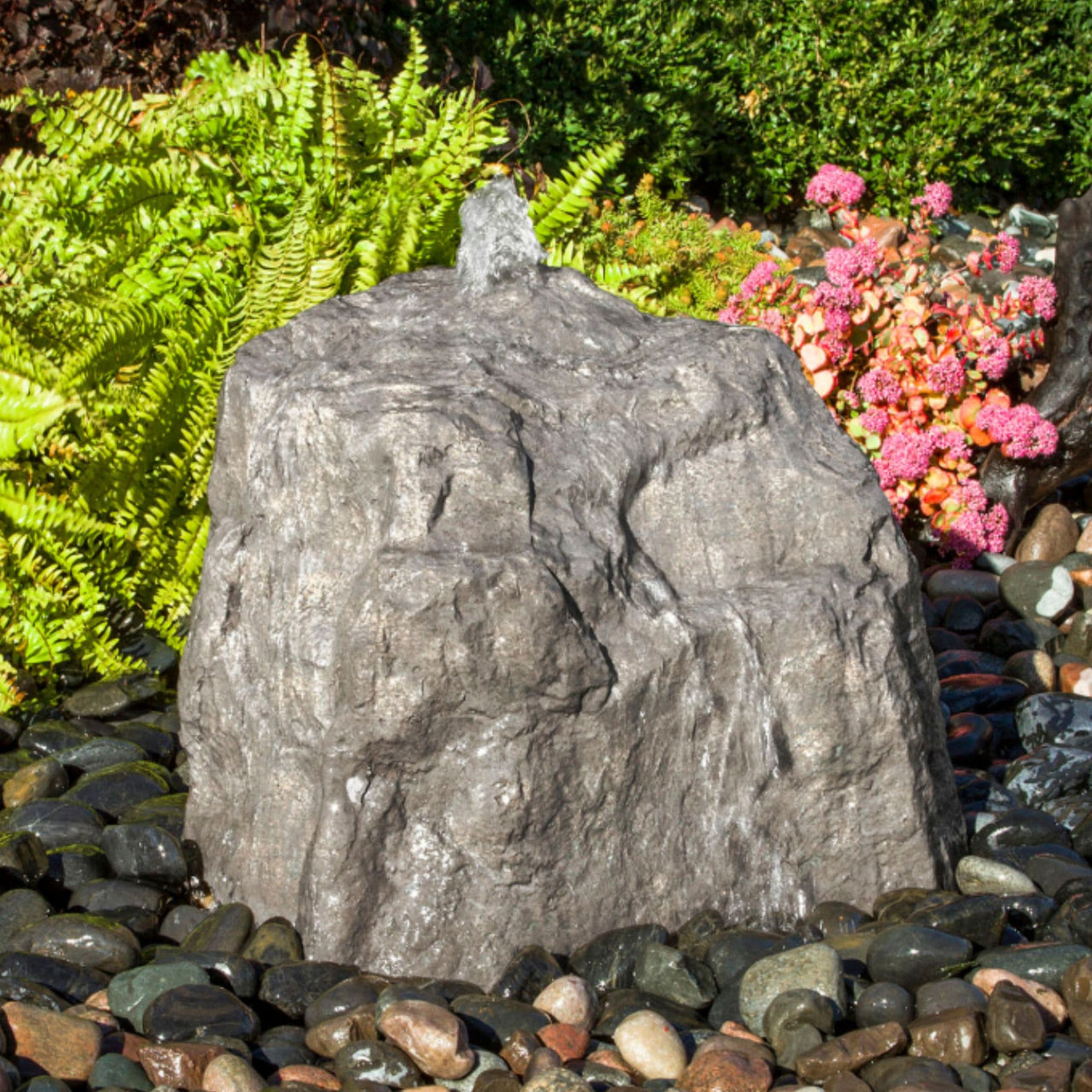 Blue Thumb Sand River Falls Stone Garden Fountain With Ferns Flowers And Small Trees Behind 
