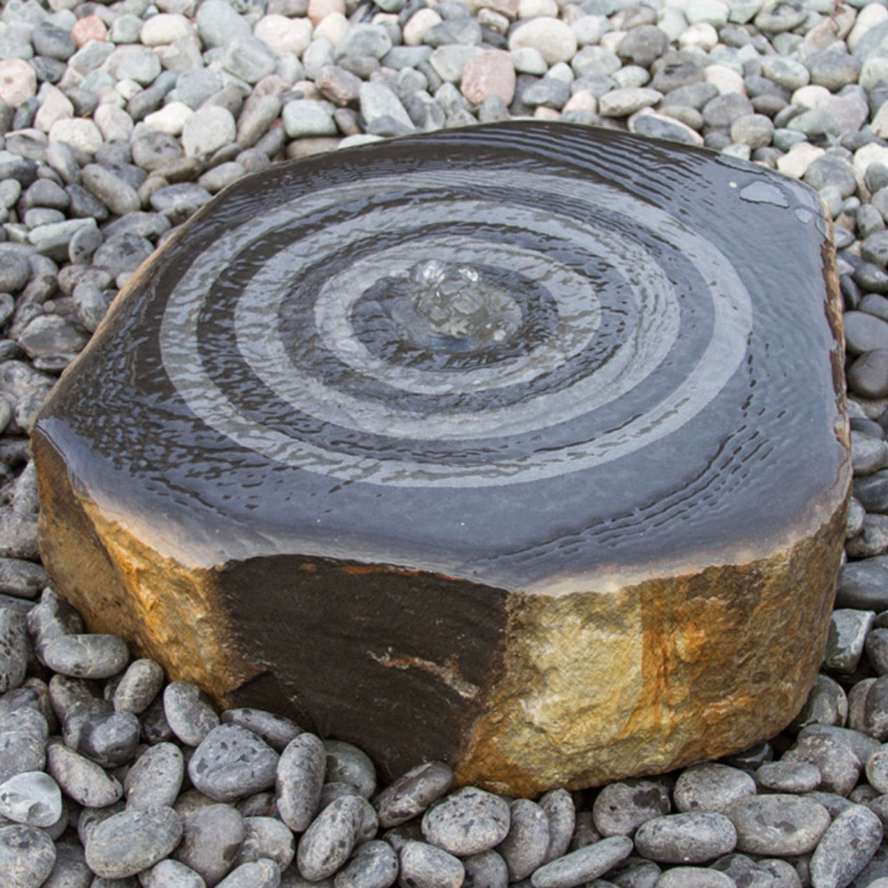 Blue Thumb Suwaru Outdoor Fountain Surrounded By Pebbles