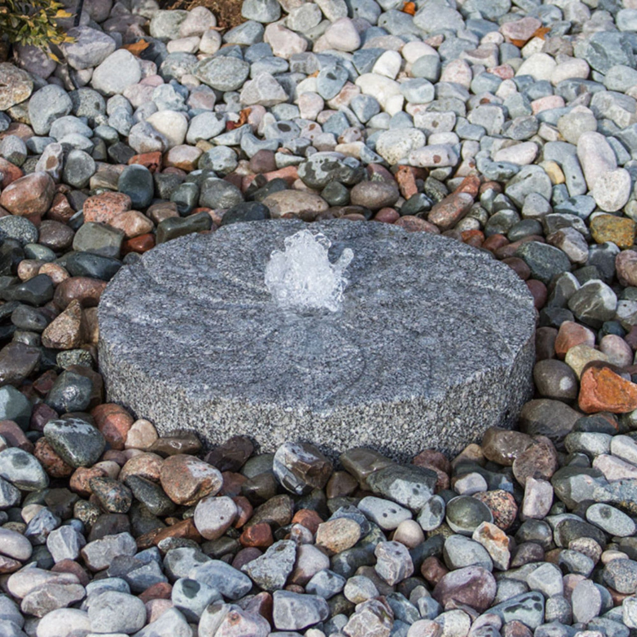 Blue Thumb Swirl Millstone Granite Stone Fountain Surrounded By Pebbles