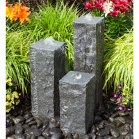 Thumbnail for Blue Thumb Triple Raw Cut - Granite Stone Fountain Surrounded By Plants And Flowers