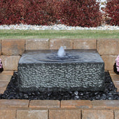 Blue Thumb Yoshida Square Stone Fountain On Black Pebbles With Red Trees In The Background