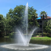Cascade Aquarius Pond Fountain With Trees And A House Under A Clear Blue Sky